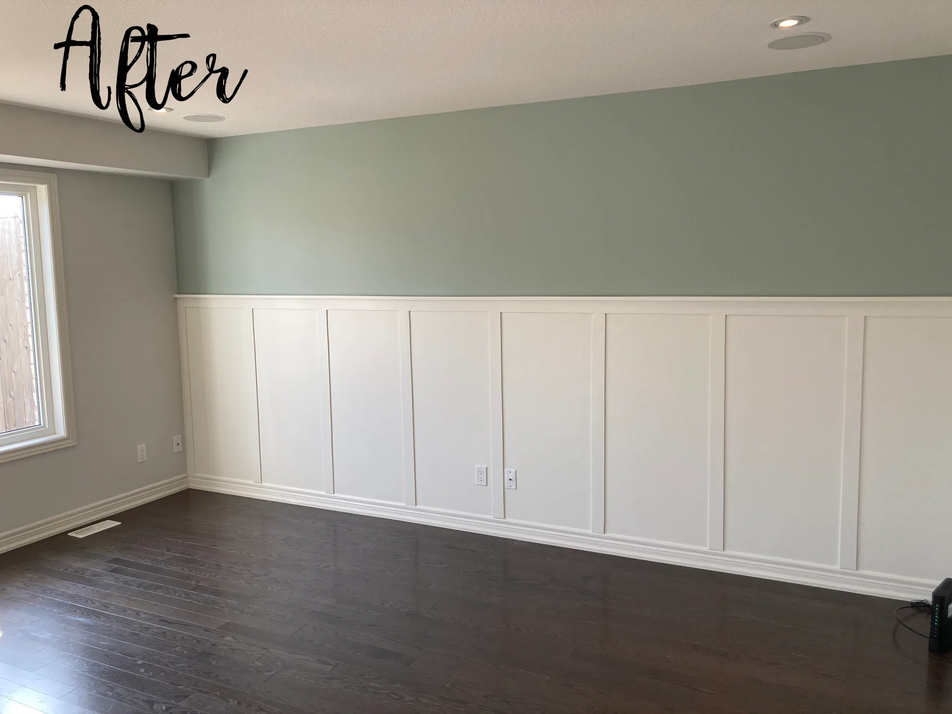 Dining room with soft green walls and freshly painted white wainscoting