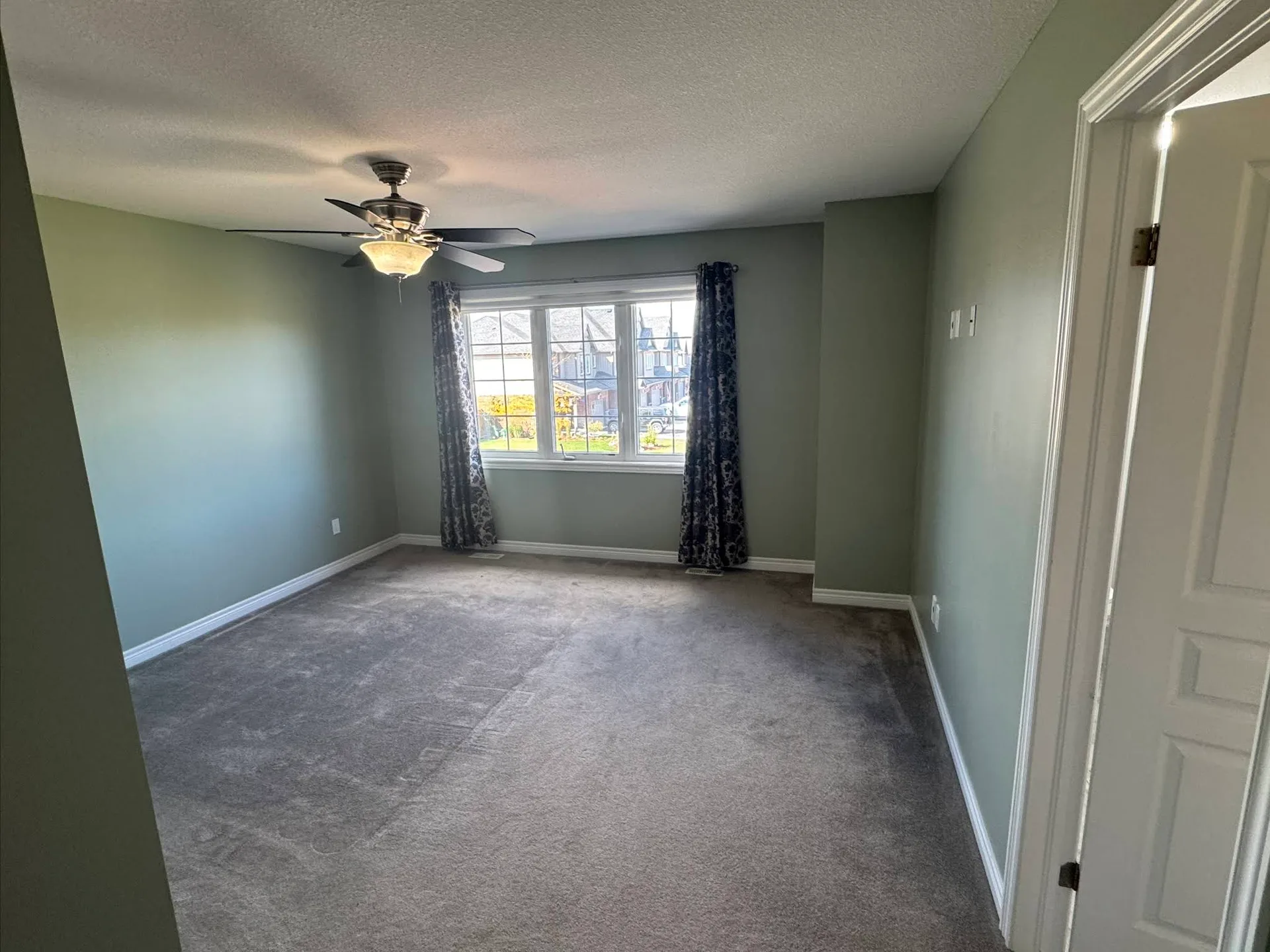Bedroom freshly painted in a calm green-grey colour